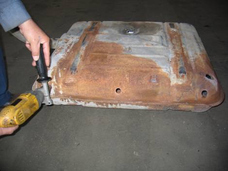 1. After the gas tank is de-fumed (cleaned) we drill holes in strategic locations to prepare for sandblasting.