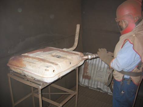 3. Sandblasting the tank in a walk-in blast room